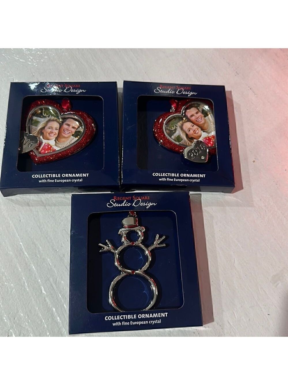3 Christmas tree ornaments. 2- 2016 heart frames and 1 snowman